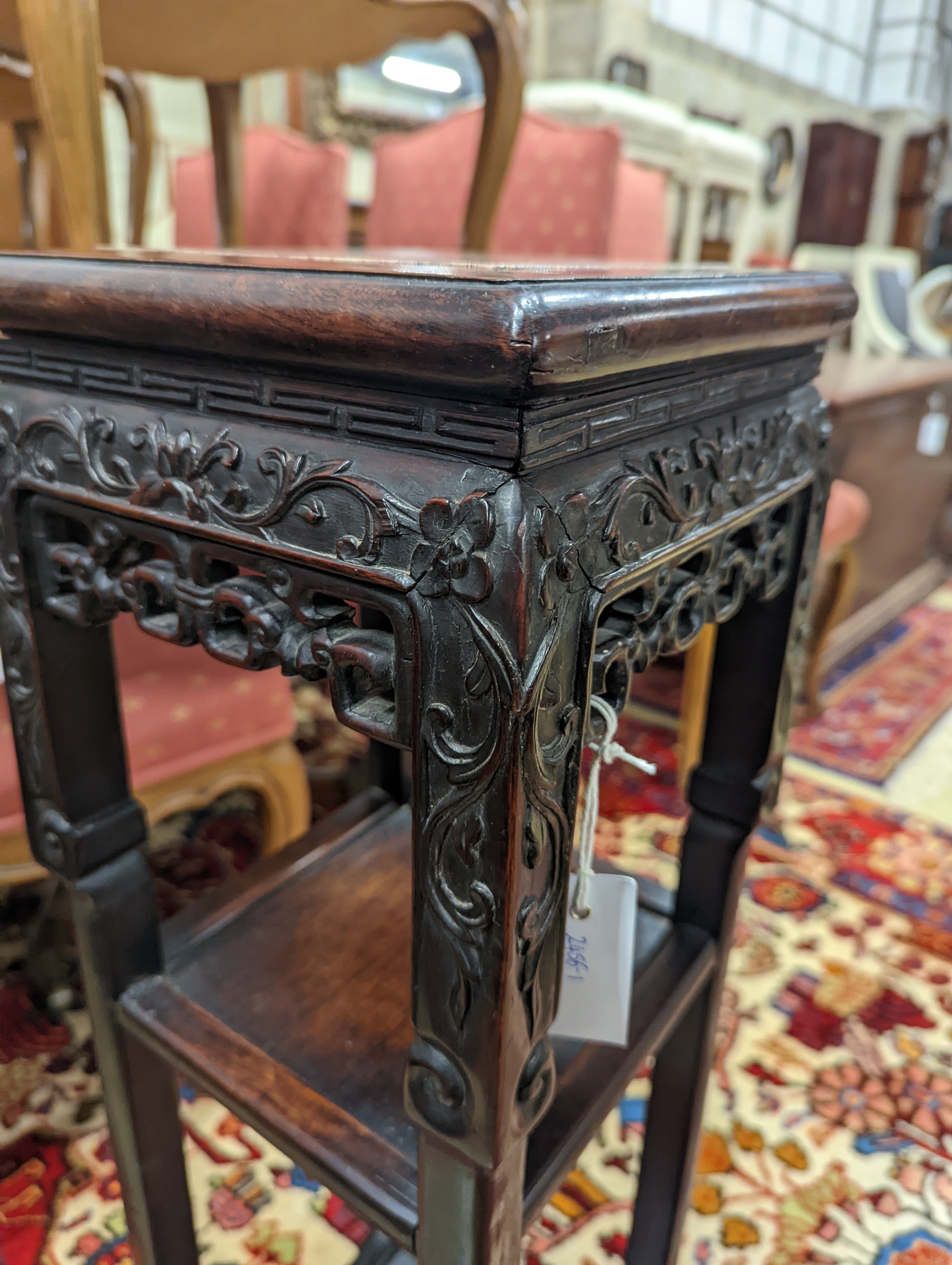 A Chinese carved hardwood three tier jardiniere stand, marble inset, width 22cm, depth 22cm, height 82cm